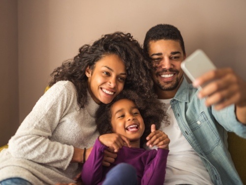 Parent and child smiling after lip and tongue tie treatment