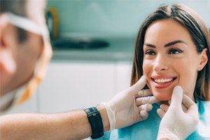 patient smiling while looking at dentist 