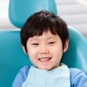 Child in dental chair smiling