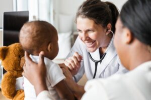 a dentist examining a child for a tongue-tie